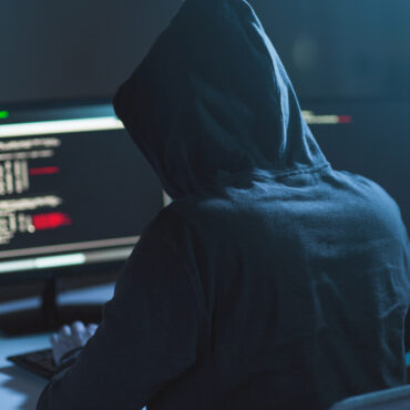 Cybercrime,,Hacking,And,Technology,Concept,-,Male,Hacker,In,Dark